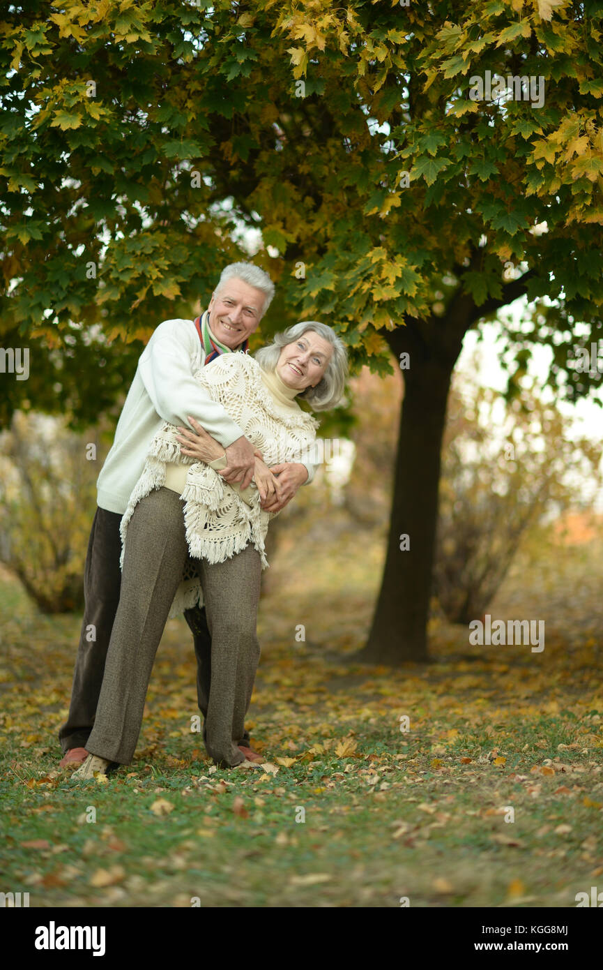 senior couple hugging in the park Stock Photo - Alamy