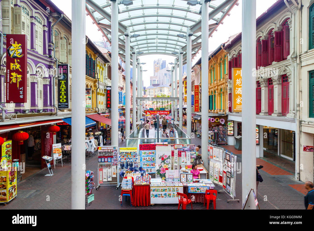 SINGAPORE - DEC. 15, 2014: Visitors shopping at Chinatown's Pagoda Street where low-rise colorful Baroque-Victorian architecture style shophouses from Stock Photo