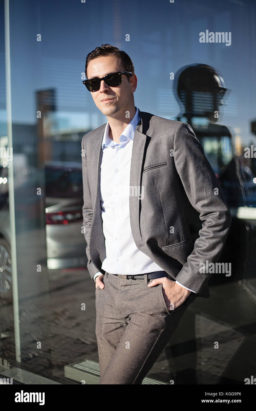 Male adult man in suit and sunglasses standing with hands in the ...