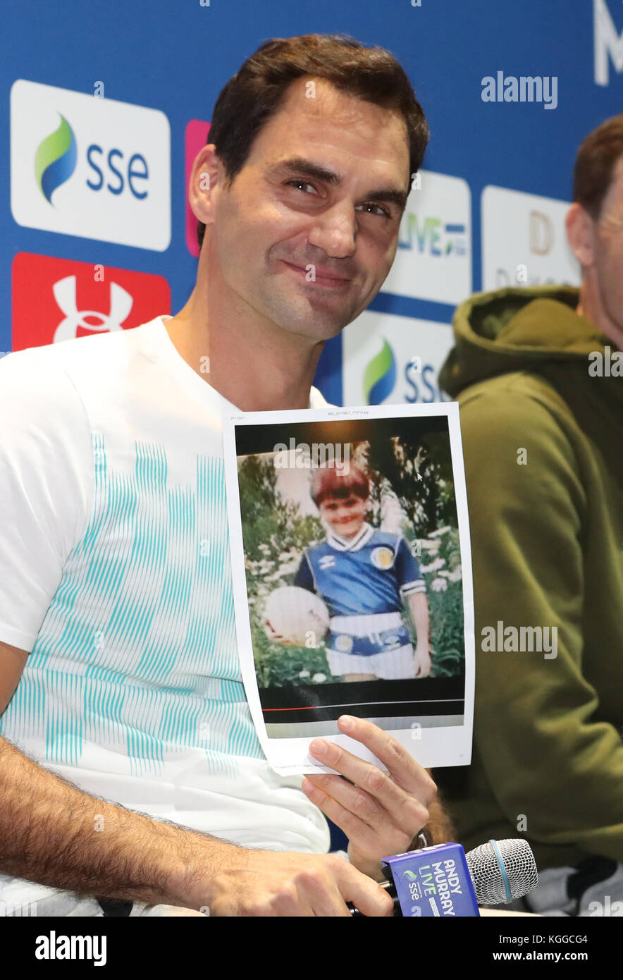 Roger Federer holds a photograph of himself aged 6 wearing a Scotland