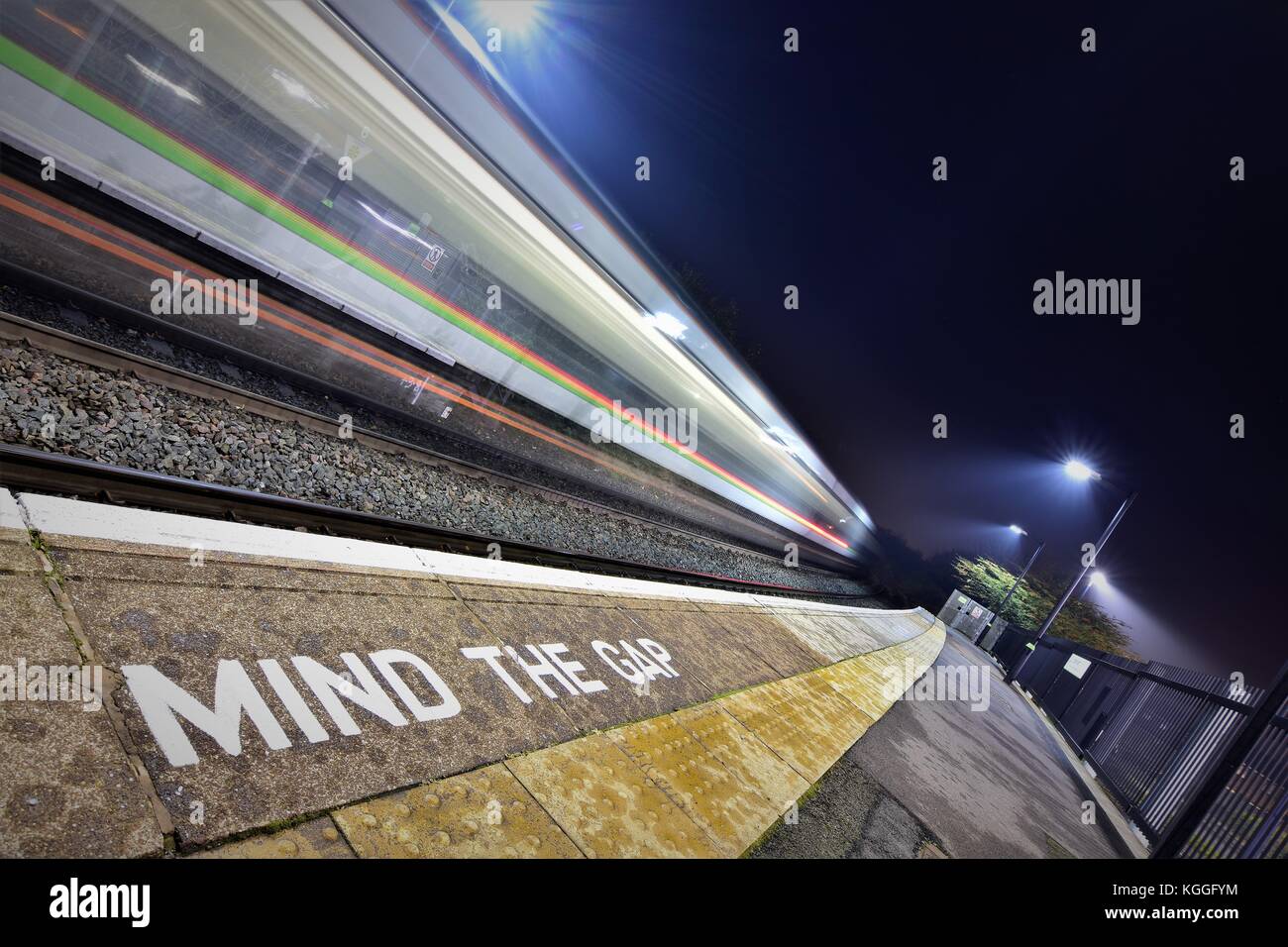 long exposure of train pulling away from station Stock Photo