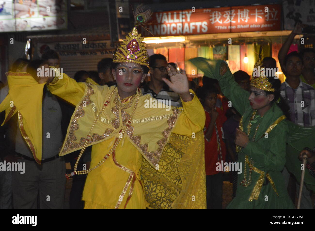 Girls in yellow dress and green dress dancing on the street at Nepalese news year's eve in April, Phokara, Nepal. Stock Photo