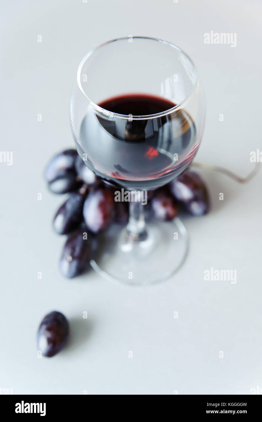 Grapes and a glass of white wine on a gray background Stock Photo