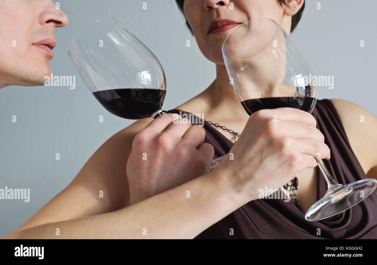 Man and woman drinking red wine from glasses. Stock Photo