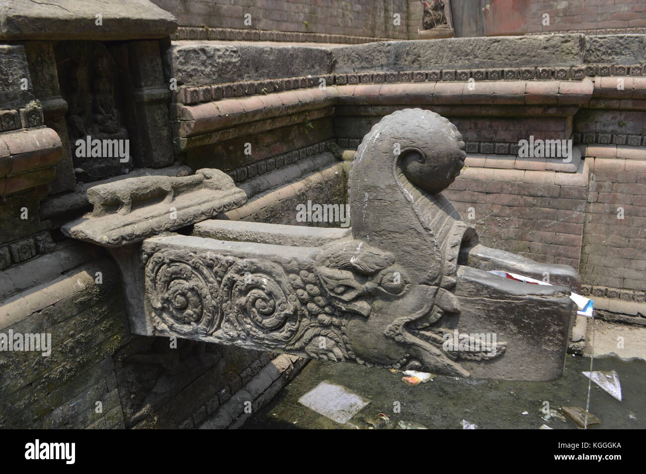 Nepalese people waiting to collect drinking water with jerrycan in ancient fountain, Kathmandu, Nepal. water shortage, drought, after earthquake Stock Photo