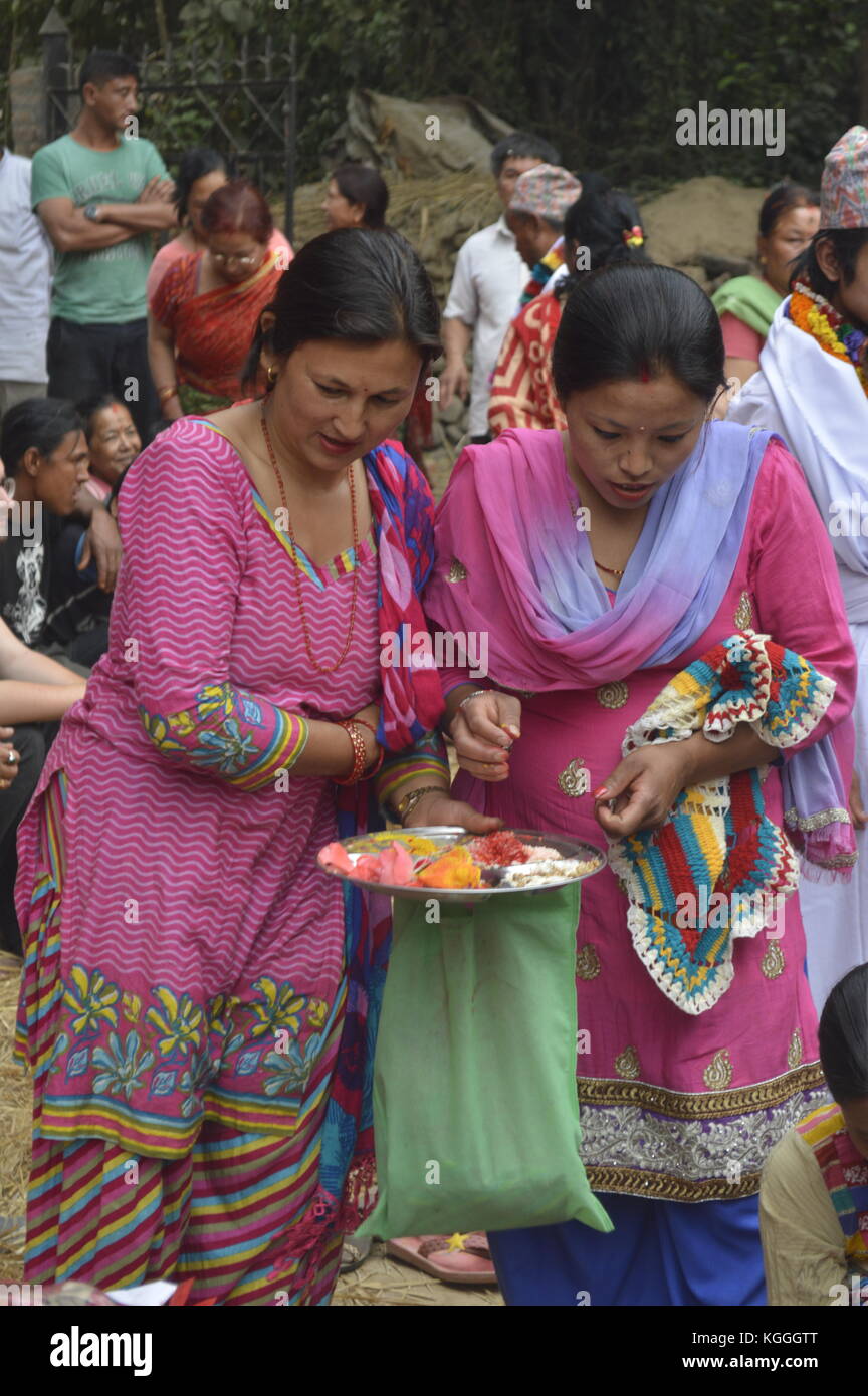 Nepali women are offering incentive and food to the gods during Jatre festival in Panauti, Nepal. Stock Photo