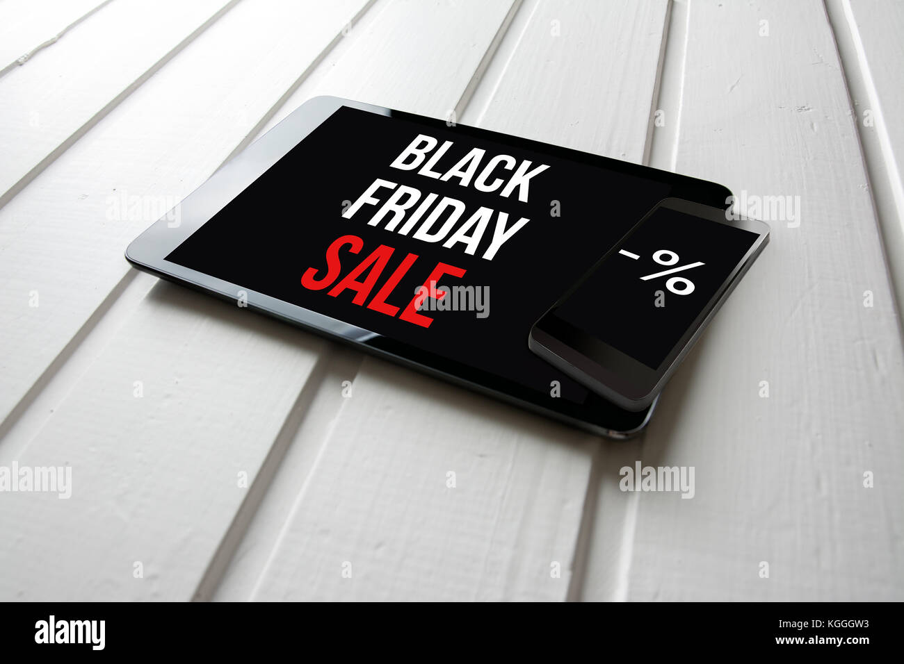 Black friday sale promotion on computer tablet screen, on white wood, online shopping concept. Stock Photo