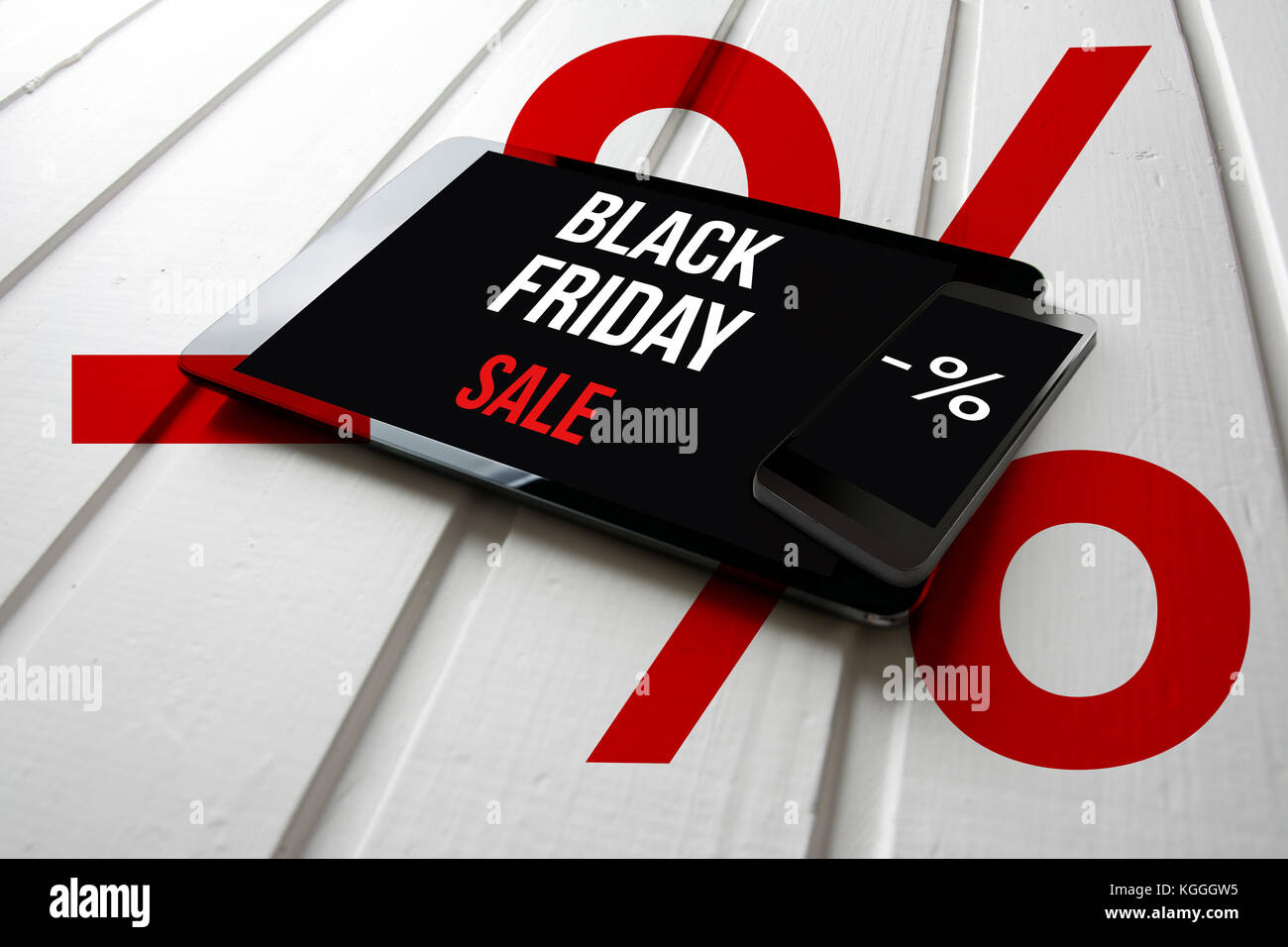 Black friday sale promotion on computer tablet screen, on white wood with percent symbol, online shopping concept. Stock Photo
