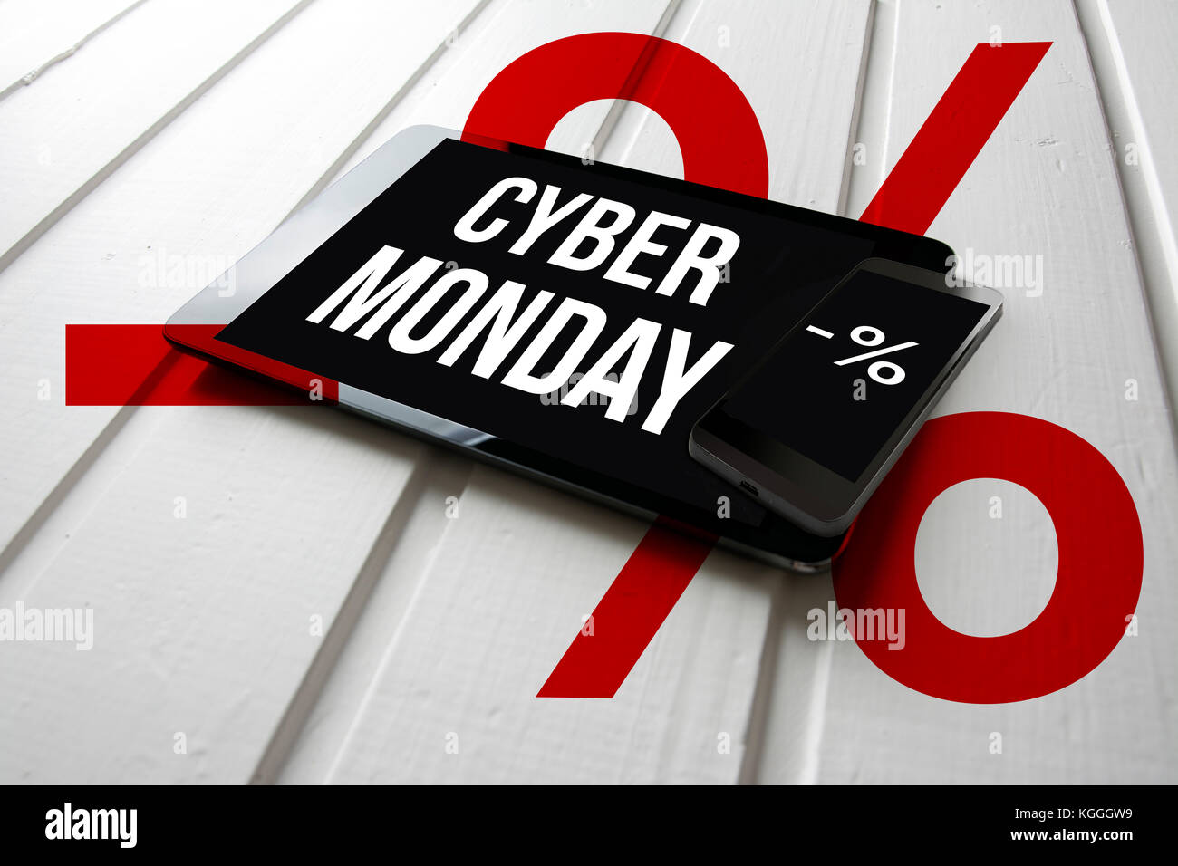 Cyber monday sale promotion on computer tablet screen, on white wood with percent symbol, online shopping concept. Stock Photo