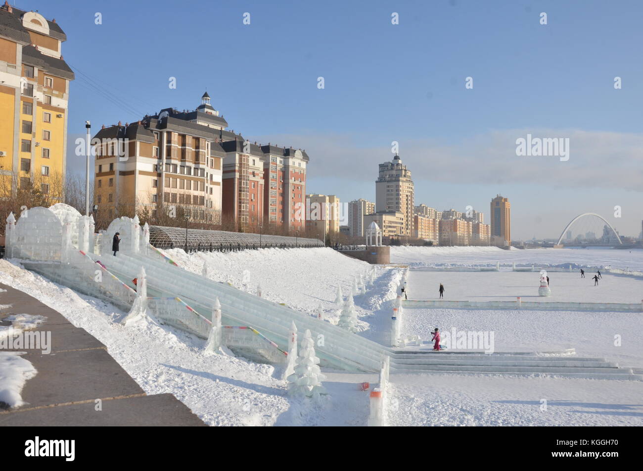 Ishim, Esil river is frozen and turned into an ice skating fun park. ice slide, Astana, capital of Kazakhstan. walking on the river, ice, water. Stock Photo