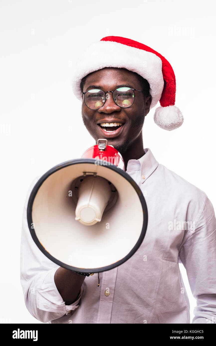 Young African American man wearing a santa hat with loudspeaker ...