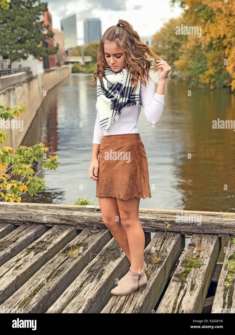 Caucasian teenage girl in short skirt on wooden bridge over river Stock  Photo - Alamy