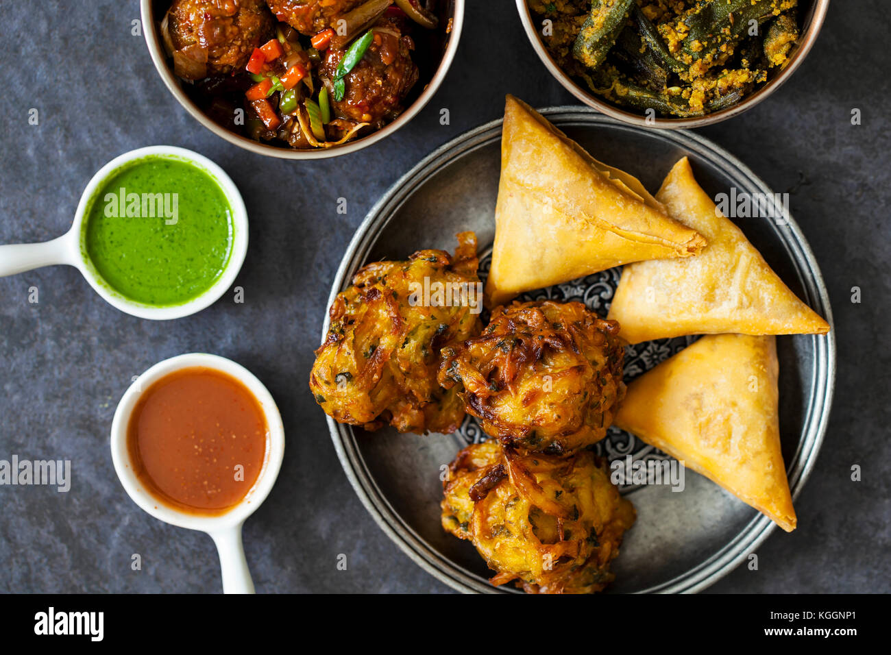 Selection of Indian dishes samosas, onion bhaji, manchurian balls and