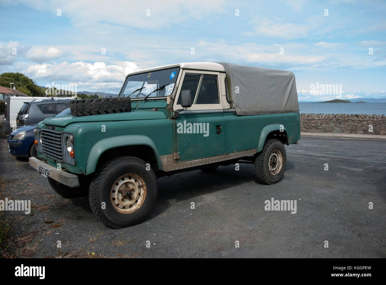 1980's Green White Land Rover Defender 110 Pick up Craighouse Isle of Jura Scotland front nearside view of 1983 rusty green white rhd right hand drive Stock Photo