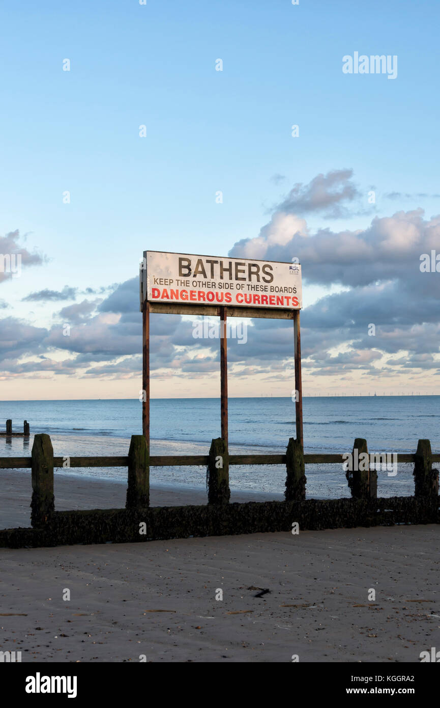 sign on Littlehampton beach UK, warning bathers of dangerous currents. Stock Photo