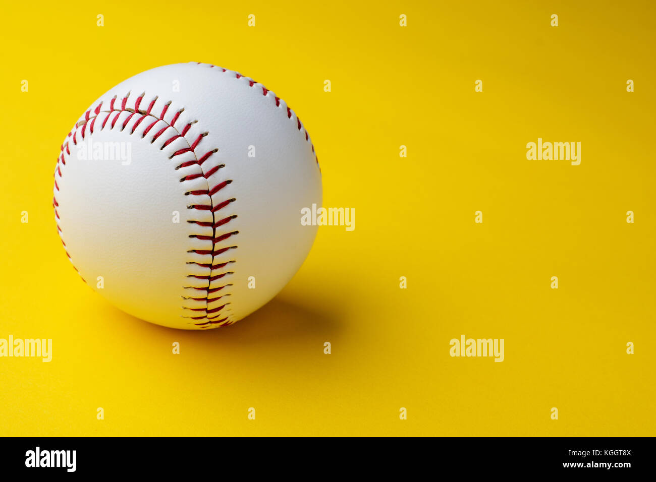 Baseball ball on yellow background with copy space Stock Photo Alamy