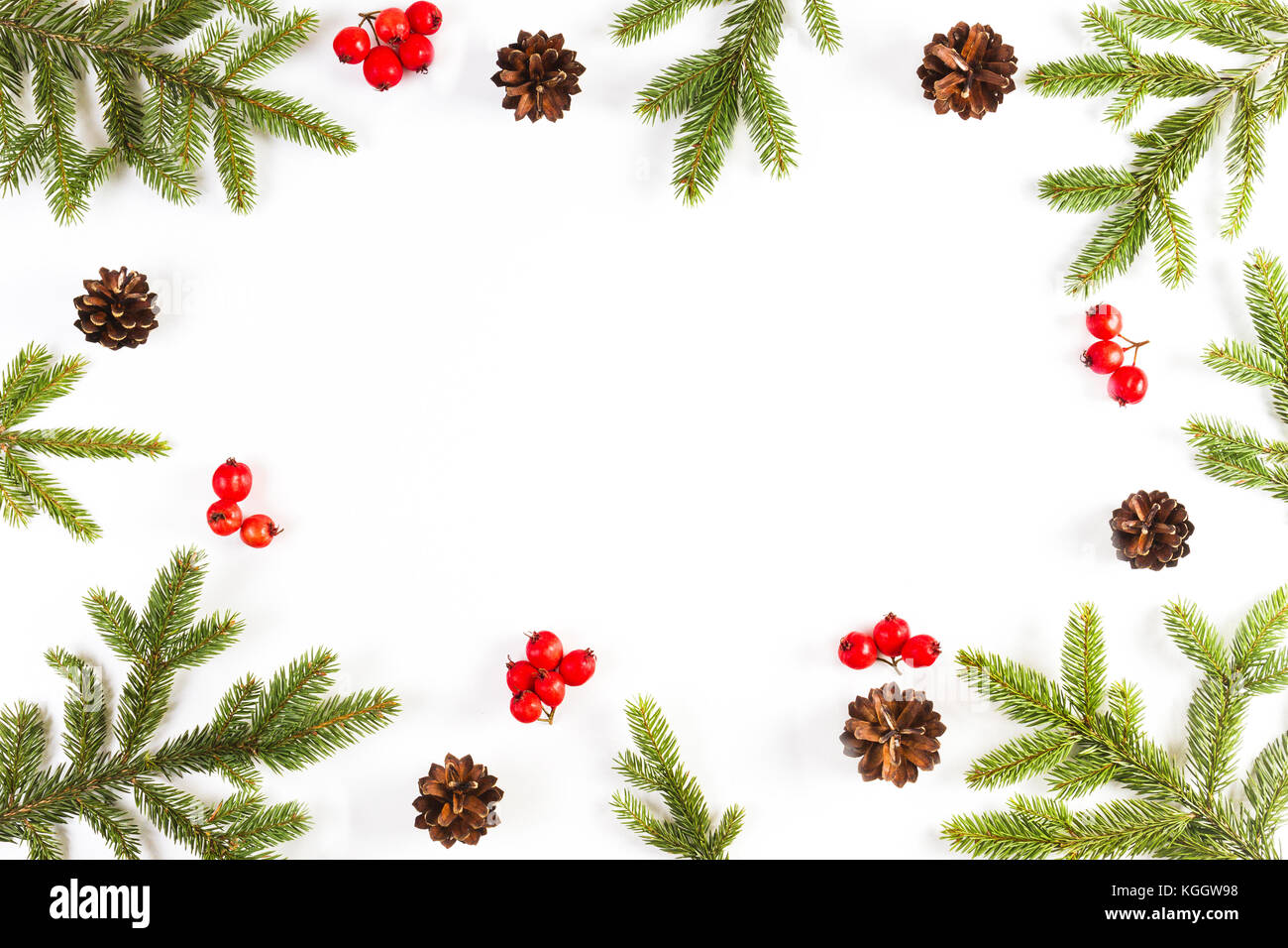 Christmas background with fir branches, pine cones and red berries on ...