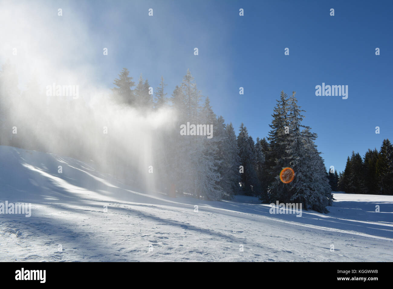 Artifical snow in the air, snow gun in action, ski resort Kopaonik, Serbia Stock Photo