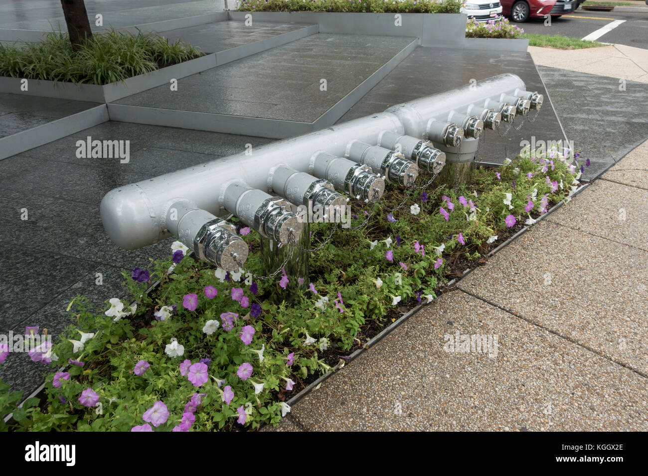 A line of dry standpipes/risers inlet pipes outside a hotel in Washington DC, United States. Stock Photo