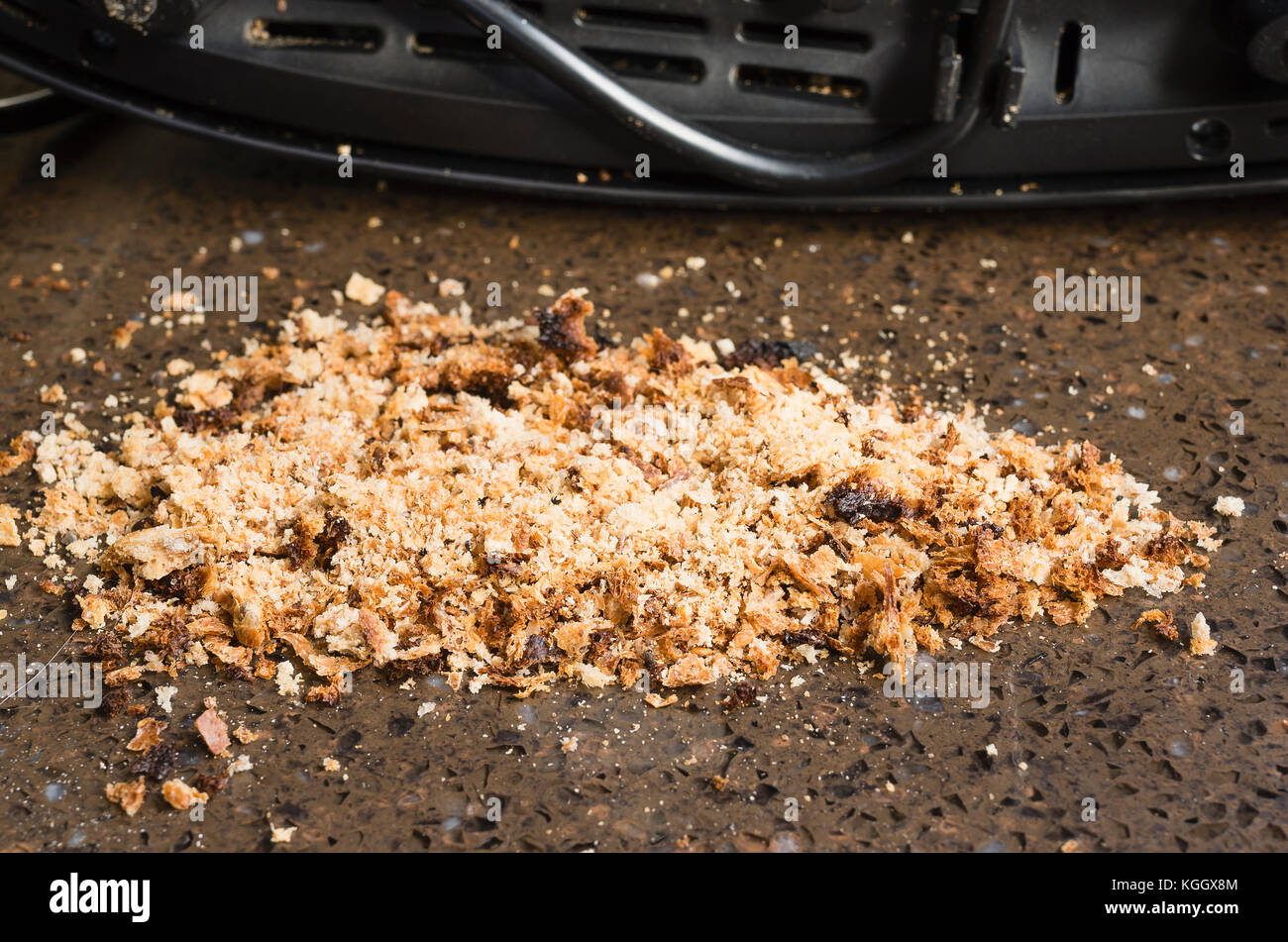 Breadcrumbs removed during weekly clean of electric toaster Stock Photo