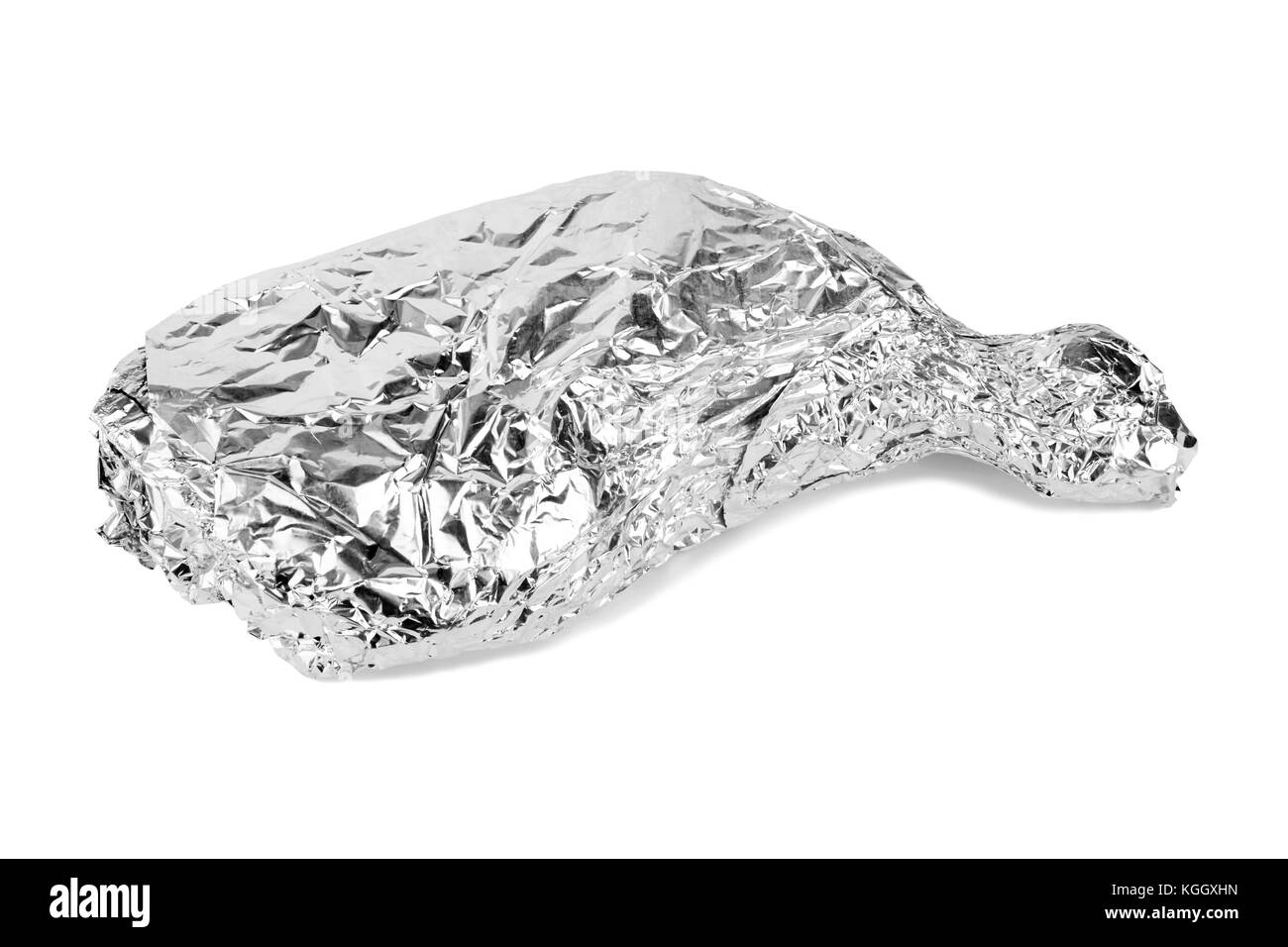 Frozen chicken leg wrapped in aluminum foil isolated on white. Stock Photo