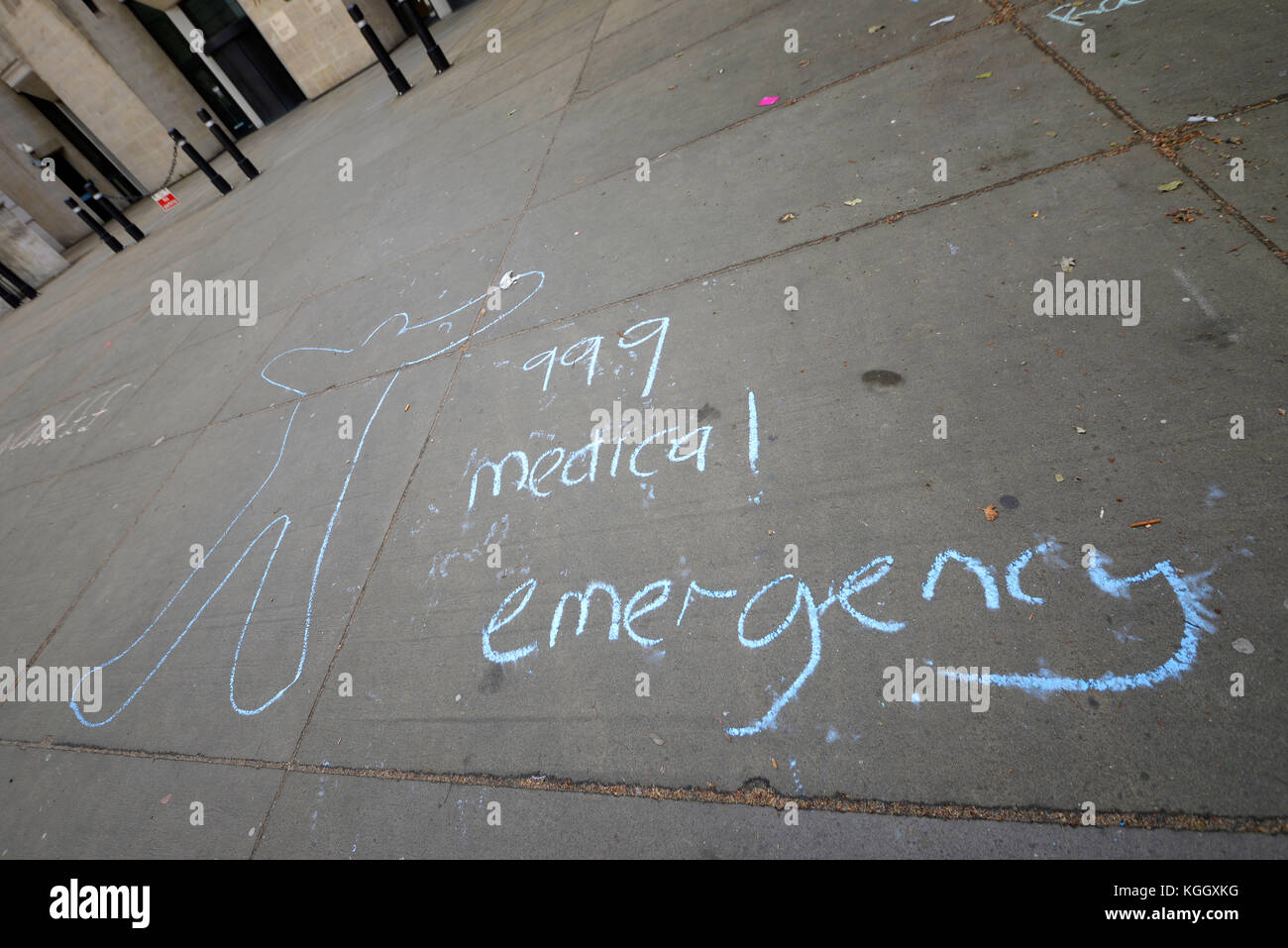 999 medical emergency chalked on the pavement with chalked outline body profile outside Richmond House, Whitehall, London Stock Photo