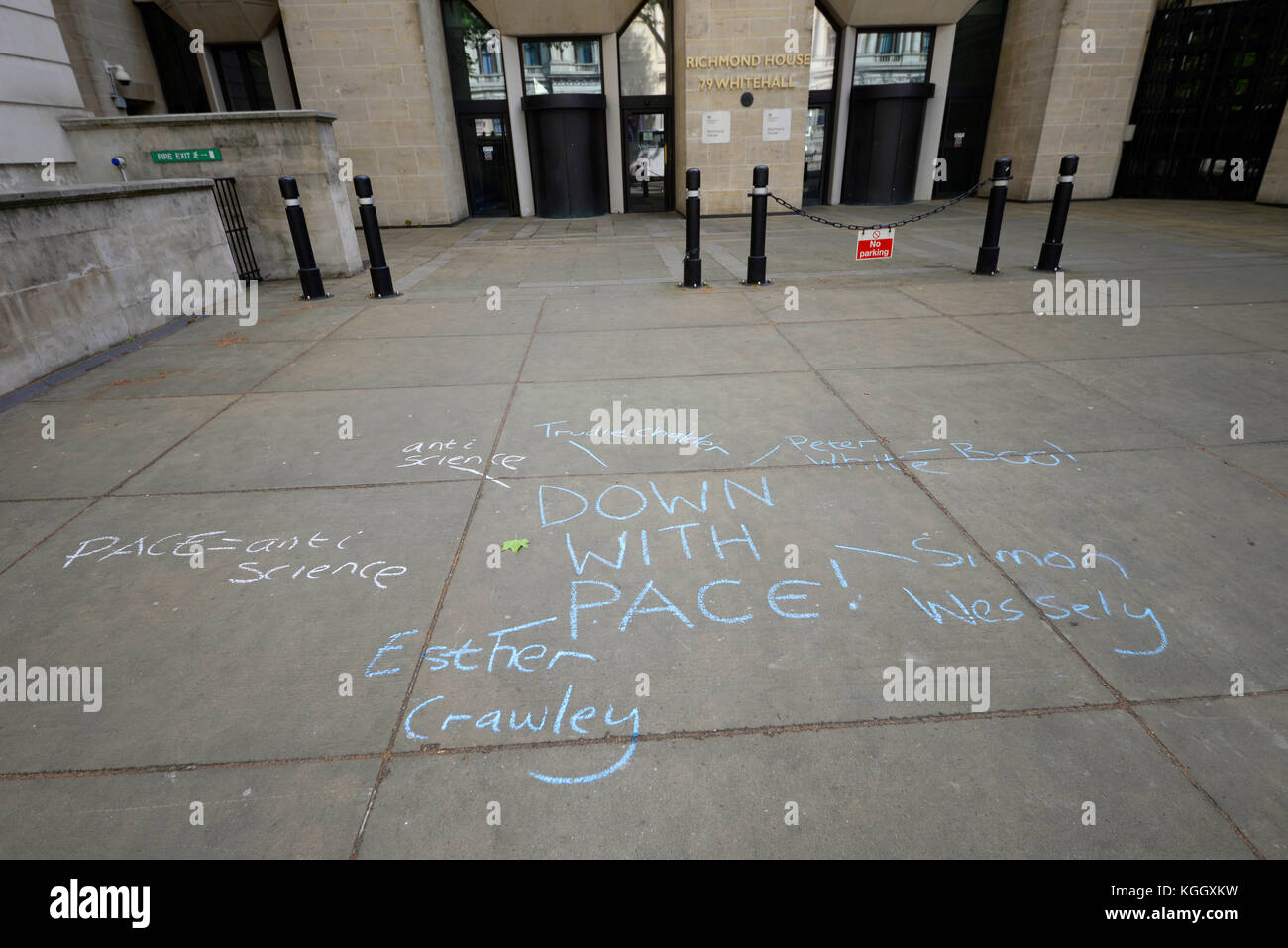 Down with PACE chalked on the pavement outside Richmond House, Whitehall, London, UK Stock Photo