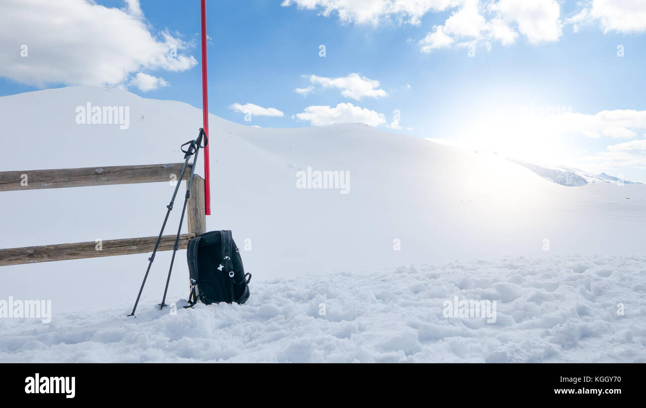 Mountain hiking equipment on the snow, active lifestyle of a lonely explorer. Sunflare effect Stock Photo