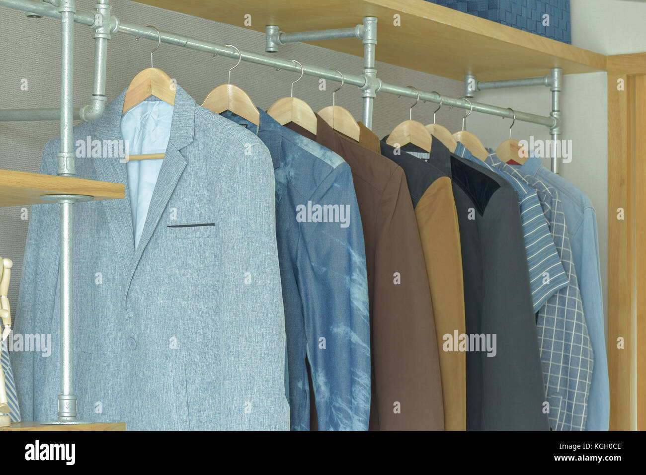 Men casual suits hanging in modern industrial style walk in closet