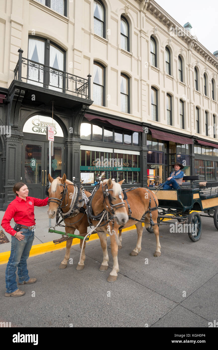 Couple with horse drawn buggy in front of the historic Geiser Grand