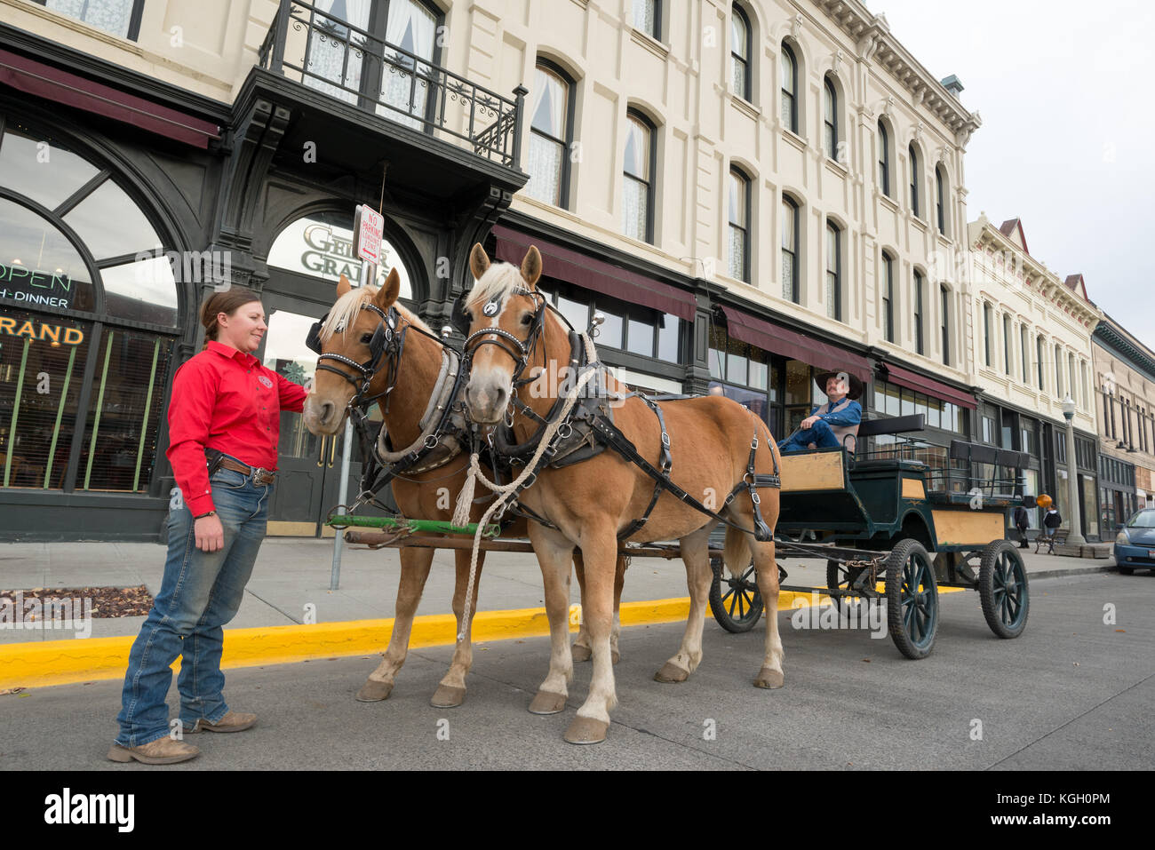 Couple with horse drawn buggy in front of the historic Geiser Grand