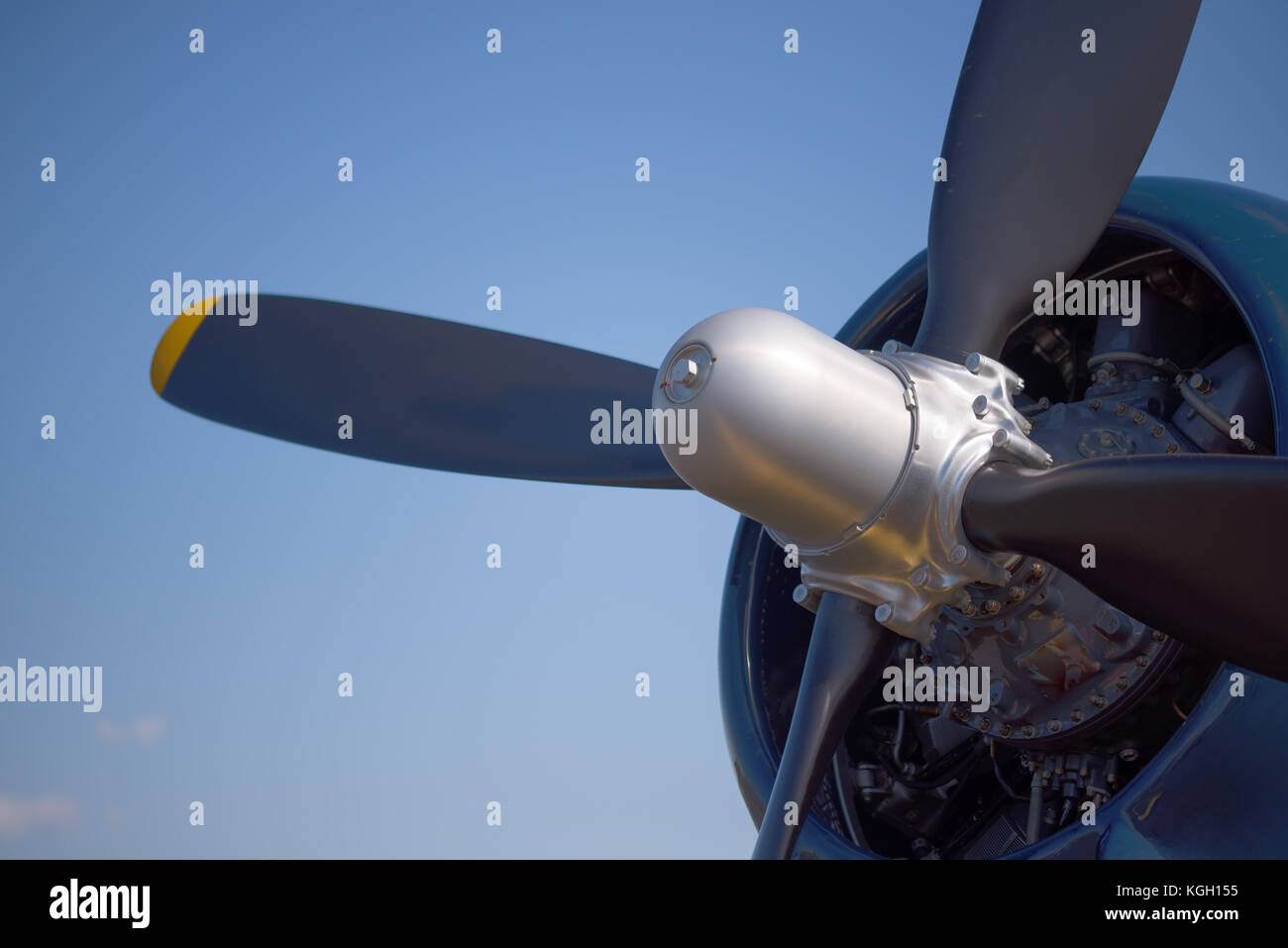 Close up of the radial engine, hub, blue cowling and propeller of a vintage World War II fighter airplane Stock Photo