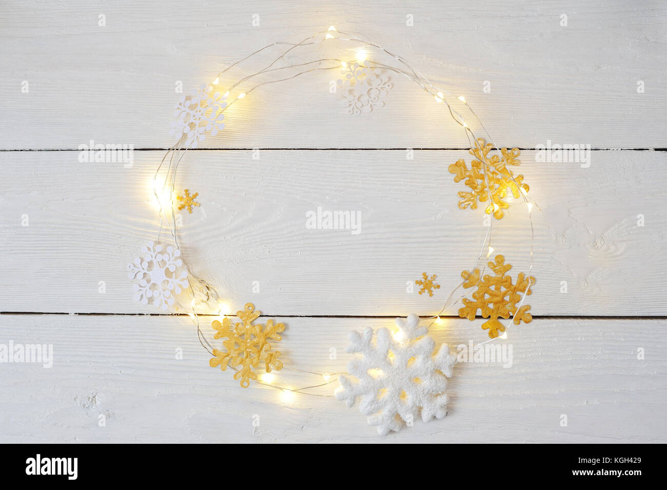 Christmas wreath of snowflakes and garlands on a white wooden background Stock Photo