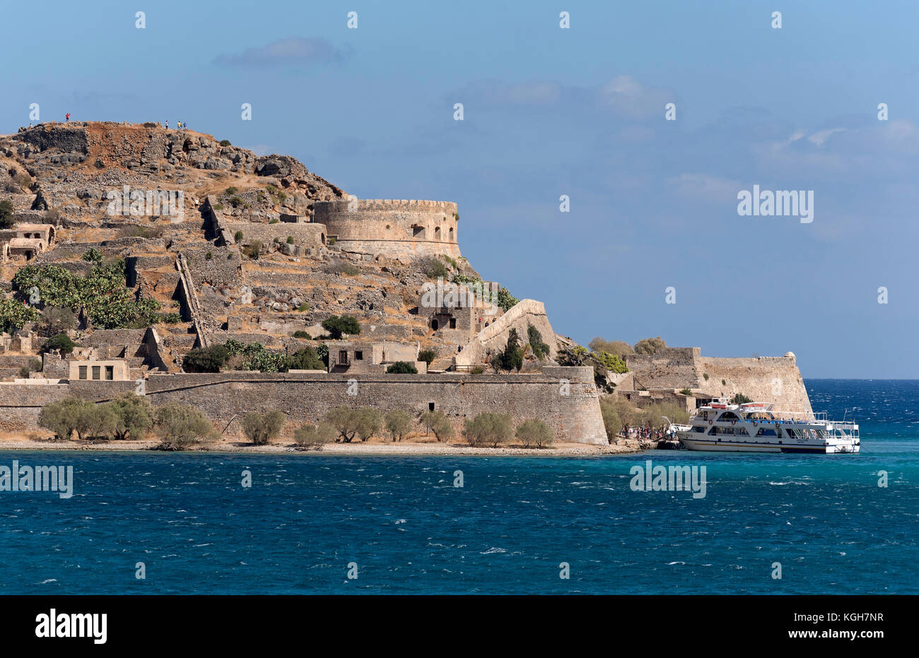 Passenger ferry off loading tourists for a visit to Spinalonga Island a ...