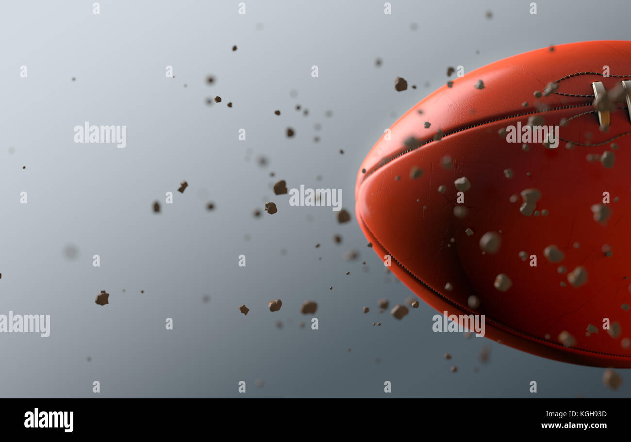 A dirty orange aussie rules ball caught in slow motion flying through the air scattering dirt particles in its wake - 3D render Stock Photo