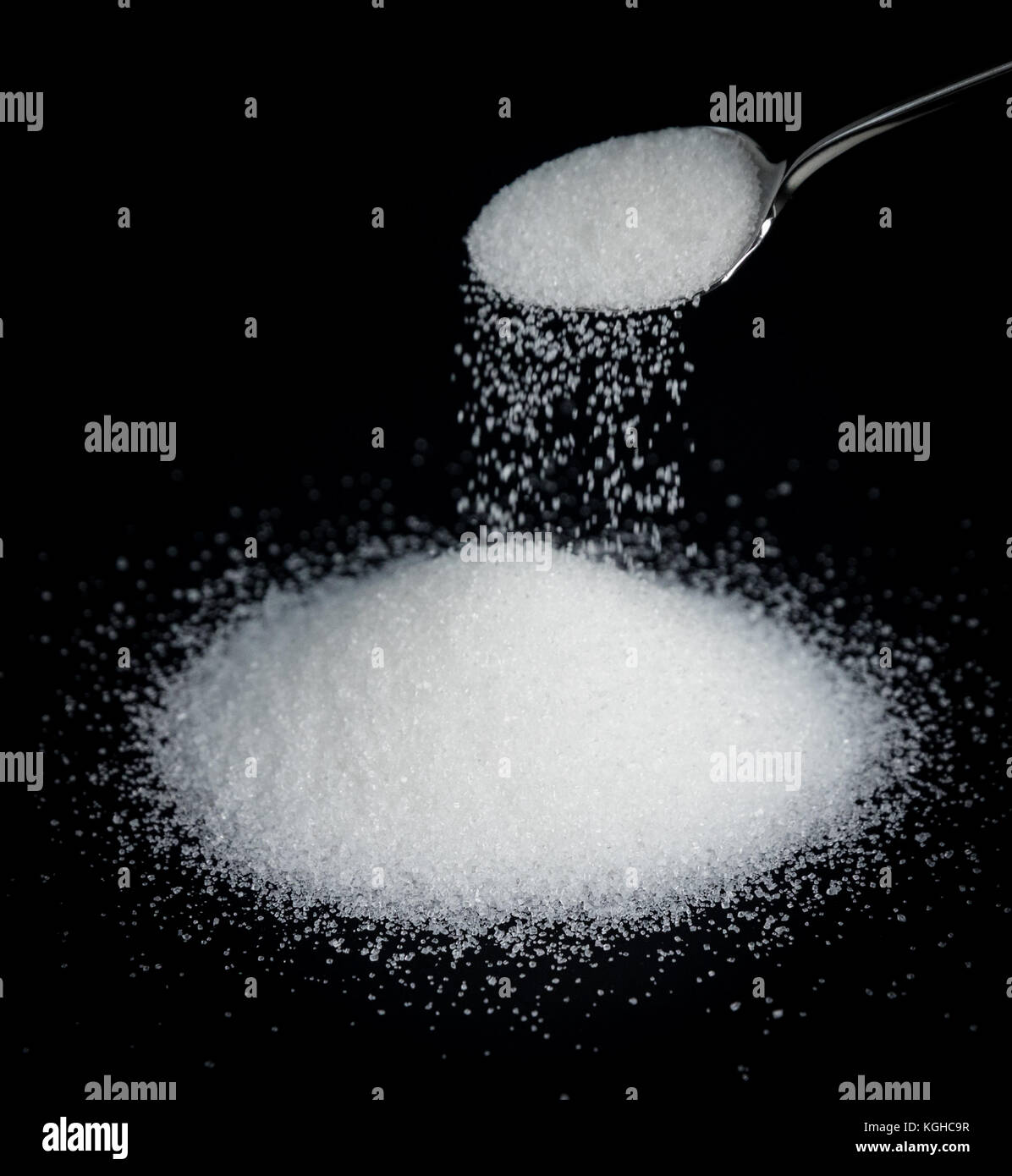 A spoonful of sugar on a black background Stock Photo
