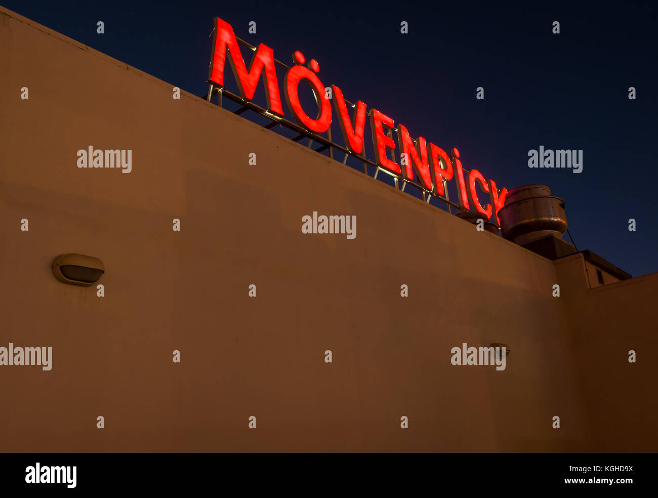 Close up of red lit up neon light at night, Movenpick hotel roof, Wadi Musa, Petra, Jordan, Middle East Stock Photo