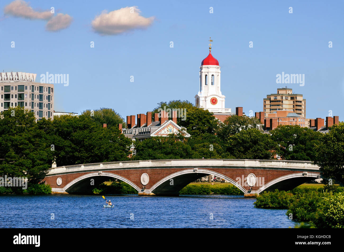 Footbridge connecting Harvard University campus across Charles River. Red dome and white clock tower of Dunster House in the background. Stock Photo
