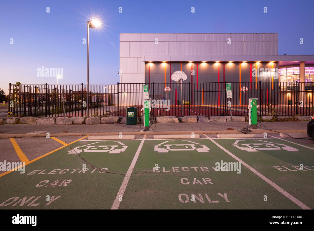 Electric vehicle parking spots and charging stations in front of Mohawk College's Fennel Campus in Hamilton, Ontario, Canada. Stock Photo