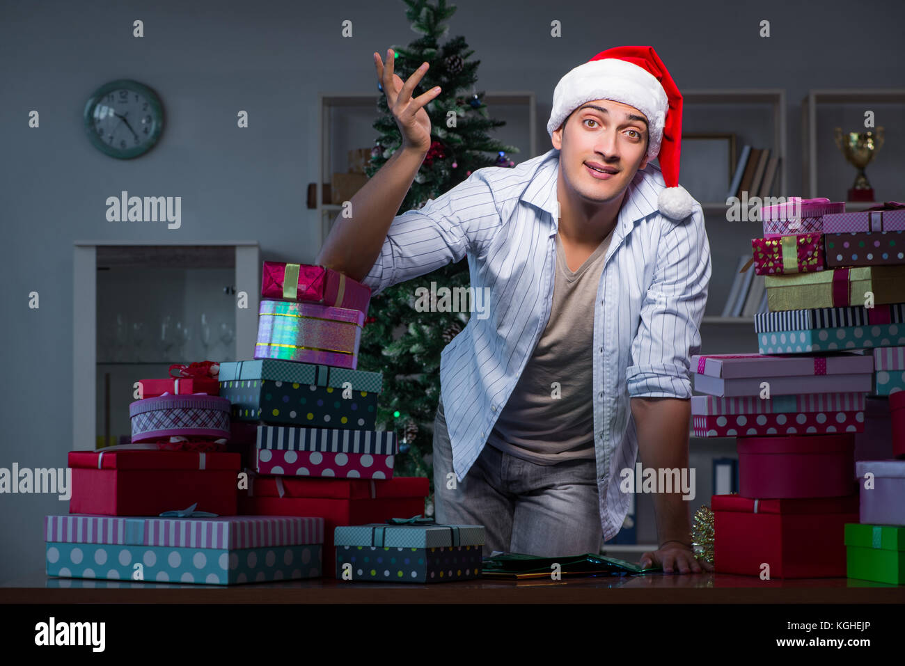 Man with many christmas gifts in boxes Stock Photo - Alamy