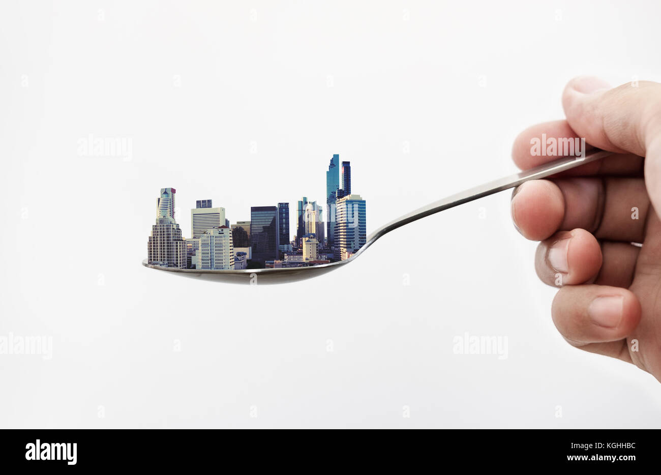 Real estate buildings on the spoon, isolated on white background. Real estate concept Stock Photo