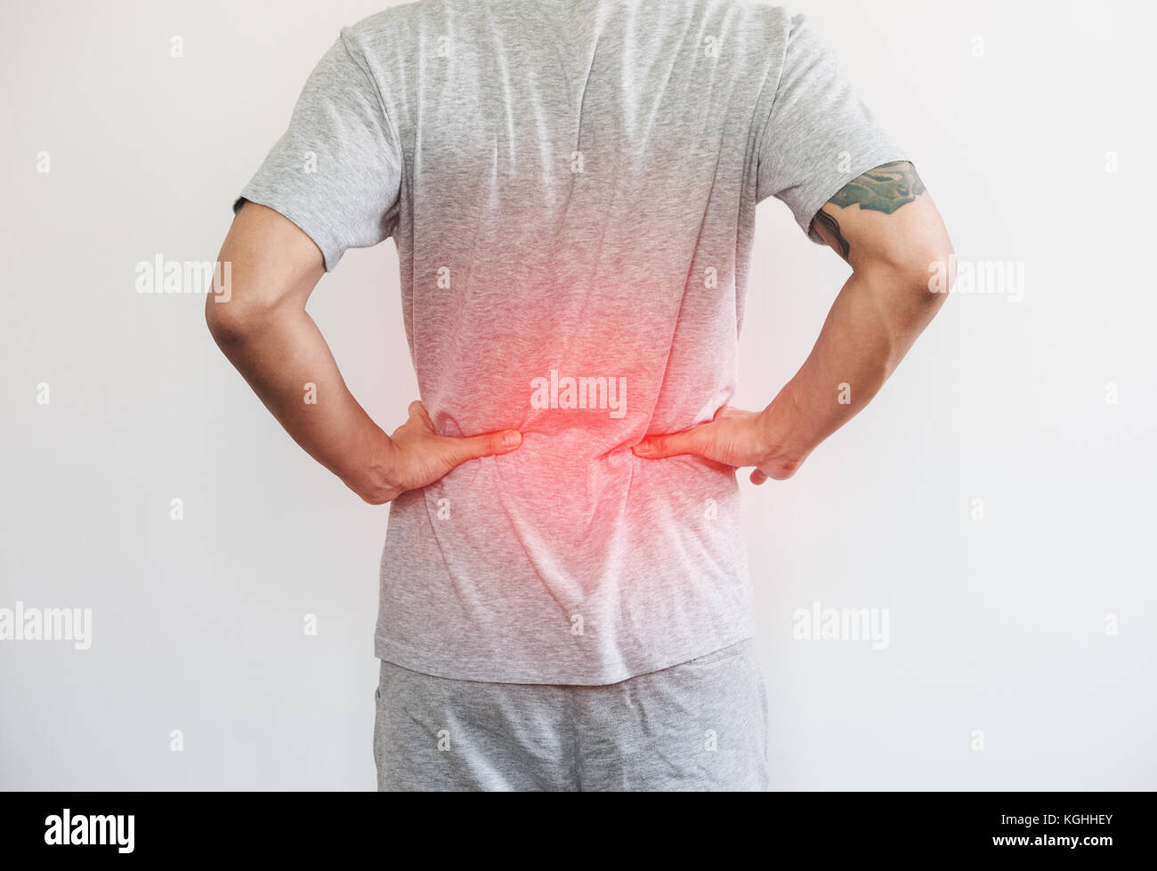 a man touching his back, with red highlight concept of back pain and waist pain concept Stock Photo