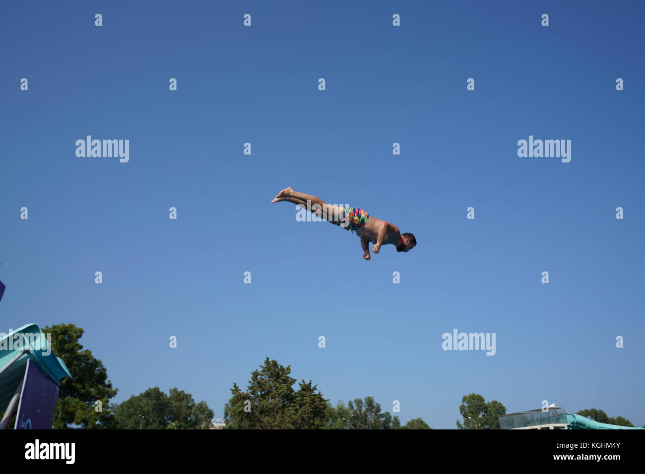 High diving: jumping in the air and flying in swimsuit Stock Photo