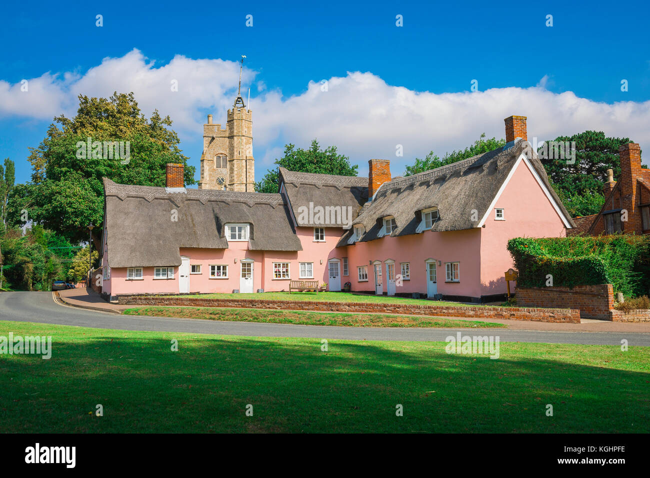 Suffolk village UK, view across the village green of a group of traditional pink cottages in Cavendish, Suffolk, Babergh district, England, UK Stock Photo