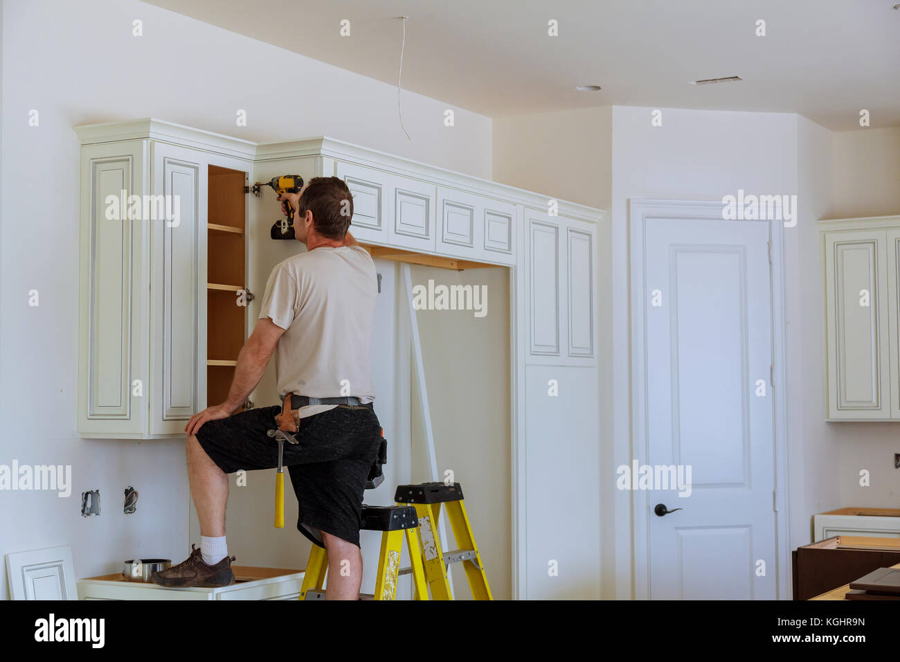 Installation of doors on kitchen Stock Photo Alamy