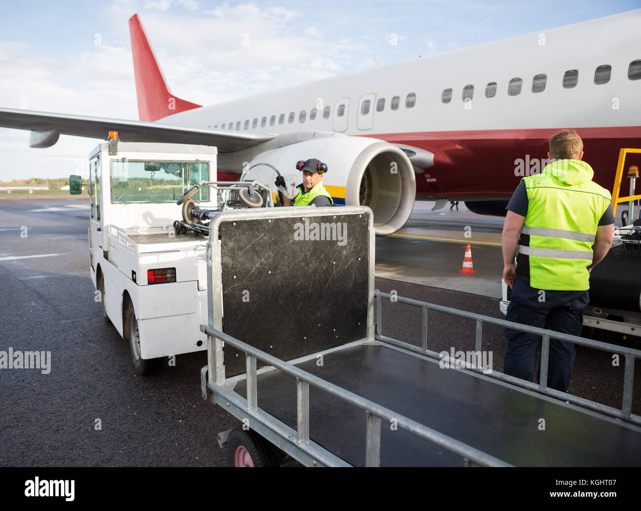 Ground Staff Working By Airplane And Truck On Runway Stock Photo