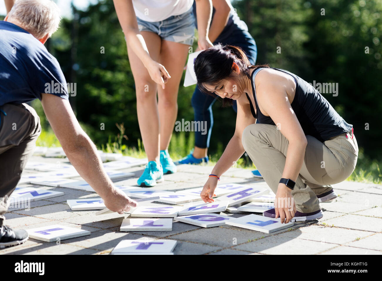 Multiethnic Friends Playing Crossword Puzzle On Patio Stock Photo Alamy