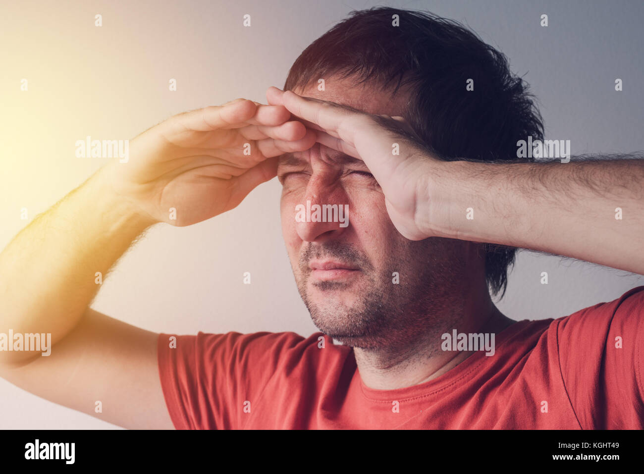 Man looking towards the bright light source. Optimistic concept of new chance, hope and solutions of problems. Stock Photo