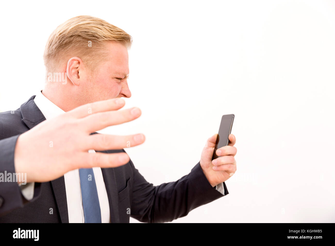 Businessman screaming while talking by phone Stock Photo