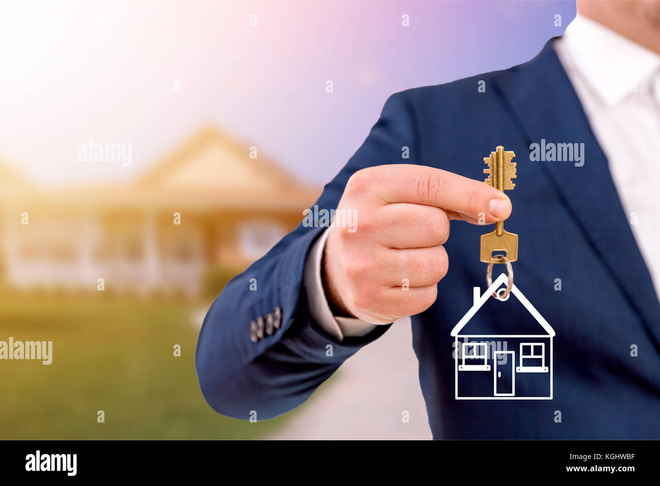 Real estate agent holding keys in front of a beautiful new home Stock ...